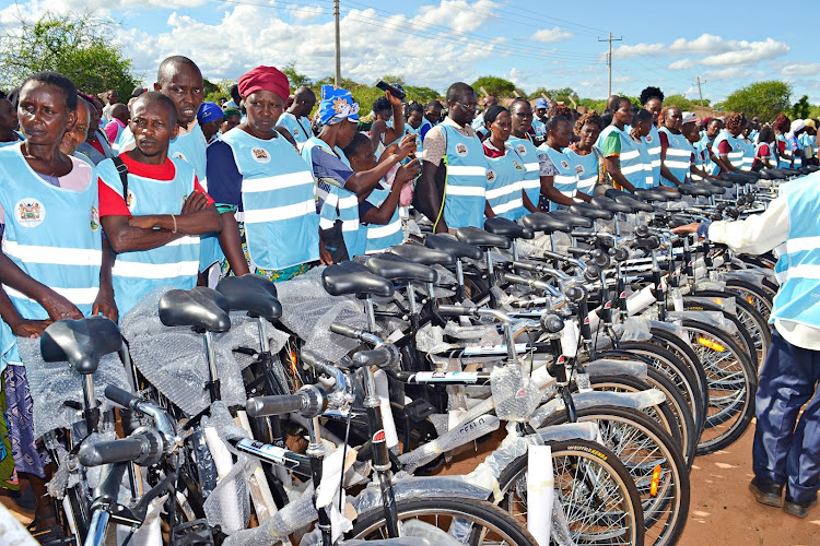 Some of the CHPs from Mwingi North sub County in Kitui who benefited from the Friday bicycle donation to ease mobility standing next to the bikes.