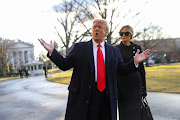 Former U.S. president Donald Trump gestures as he and his wife Melania Trump depart the White House to board Marine One ahead of the inauguration of president Joe Biden in Washington on January 20, 2021.
