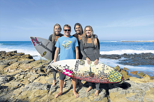 NEW WAVE: Four-time SA surfing champ Greg Emslie, second left, with Billabong SA's top women surfers Emma Smith, left, Tanika Hoffman, and Gina Smith at Queensberry Bay this week Picture: STEPHANIE LLOYD