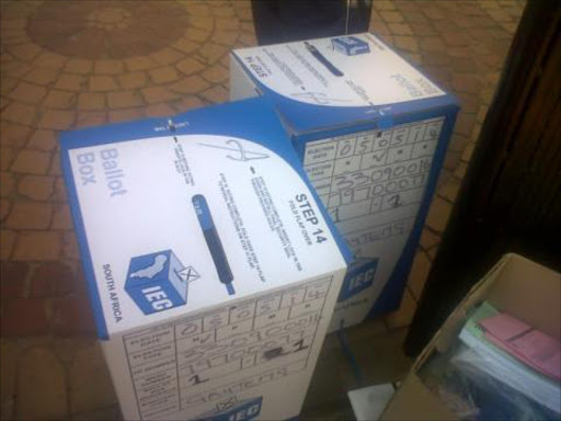 The tweet accompanying the photo reads: "#IEC material & Ballot Boxes found allegedly at the house of an #ANC party agent in KwaThema pic.twitter.com/OGWein0IRA"