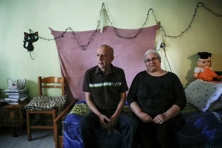 Periklis Fryganas, 61 and and his wife Sotiria, 54, sit in the living room of the apartment they recently lost due to debts, in the Egaleo working class neighbourhood, west of Athens, Greece, on April 3 2024. File photo: LOUISA GOULIAMAKI/REUTERS