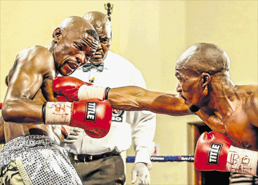 FEELING THE PAIN: Nkosinathi Joyi, left, has not fought since losing against Simpiwe Konkco, right, at Orient Theatre in December last year Picture: NICK LOURENS
