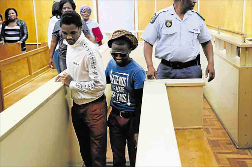 Thobela Nayi-Nayi and Thulani Mrawuli heading to the cells after being sentenced in the East London High Court. Picture: Mark Andrews