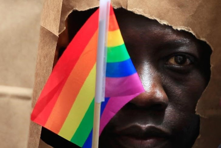 An asylum seeker from Uganda covers his face with a paper bag to protect his identity. Picture: REUTERS/JESSICA RINALDI