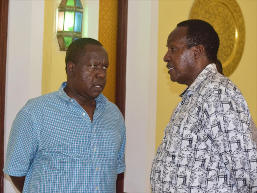 Interior CS Fred Matiang’i and chairman of the National Assembly Committee on Security Paul Koinange at the Flamingo Beach Hotel, Mombasa, on Friday /CHARLES MGHENYI
