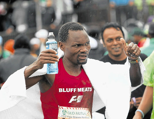 GRATEFUL: Three-times Comrades winner Stephen Muzhingi celebrates after winning the 2012 Old Mutual Two Oceans ultra-marathon in Cape Town last Saturday Picture: ESA ALEXANDER