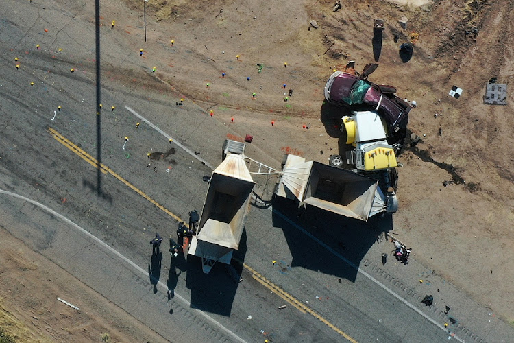 California Highway Patrol (CHP) officers investigate a crash site after a collision between a Ford Expedition sport utility vehicle (SUV) and a tractor-trailer truck near Holtville, California, US in an aerial photograph March 2, 2021.