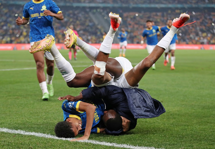 Tashreeq Matthews is rugby-tackled by teammate Peter Shalulile celebrating the former's goal as Mamelodi Sundowns beat Kaizer Chiefs 5-1 in their DStv Premiership match at FNB Stadium in Johannesburg on Thursday night to clinch the 2023-24 title.