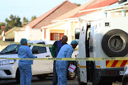 Police investigate the scene after a heist in East London.