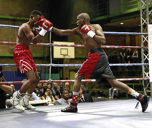 Top-rated junior bantamweight contender Sikho 'Sequence' Nqothole, right, lands a punch on his opponent. He faces Immanuel Joseph on Sunday.