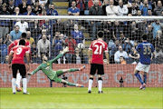 BEATEN: Leicester  fans look on as David Nugent of Leicester City scores his team's second goal from the penalty spot past the diving David de Gea of Manchester United during their league match yesterday Photo: Mike Hewitt/Getty Images