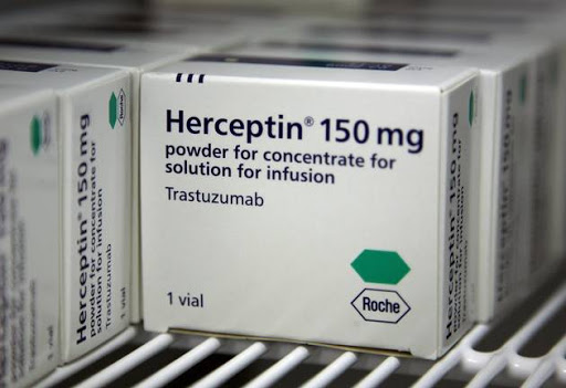 Packets of Herceptin sit on a pharmacy shelf.