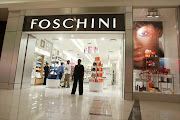 A shop assistant at the entrance to a Foschini store in Clearwater Mall, Johannesburg. Stores are unlikely to create new jobs, says an analyst