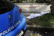 A white sheet covers the place where a man deposit the head of a British woman after decapitated her in a supermarket in Los Cristianos, on the Spanish resort island of Tenerife.