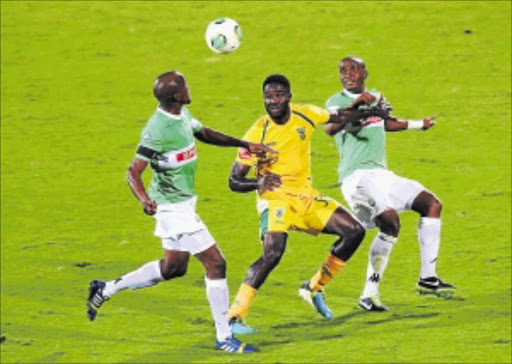 LAST STAND: Festus Mbewe of Golden Arrows is sandwiched between two AmaZulu players on Monday Photo: Anesh Debiky/Gallo Images