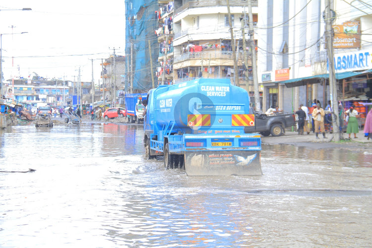A water bouser passes through a flooded section of the road in Nairobi's Pipeline area on May 1, 2024.