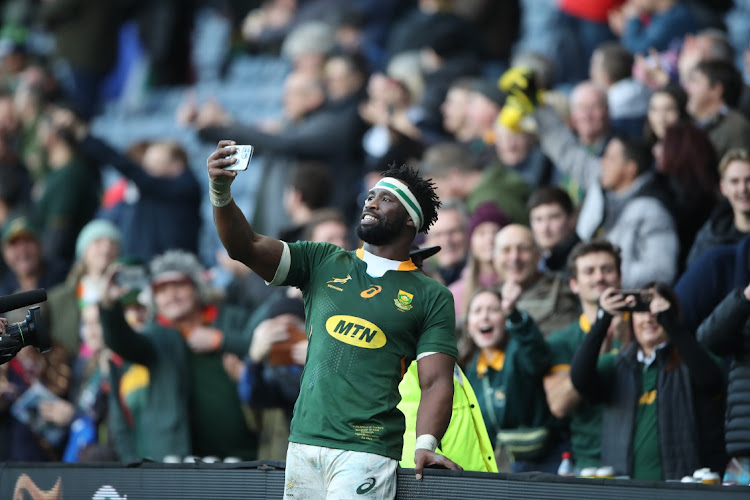 Springbok captain Siya Kolisi takes selfies with fans after the match against Scotland at Murrayfield last Saturday.