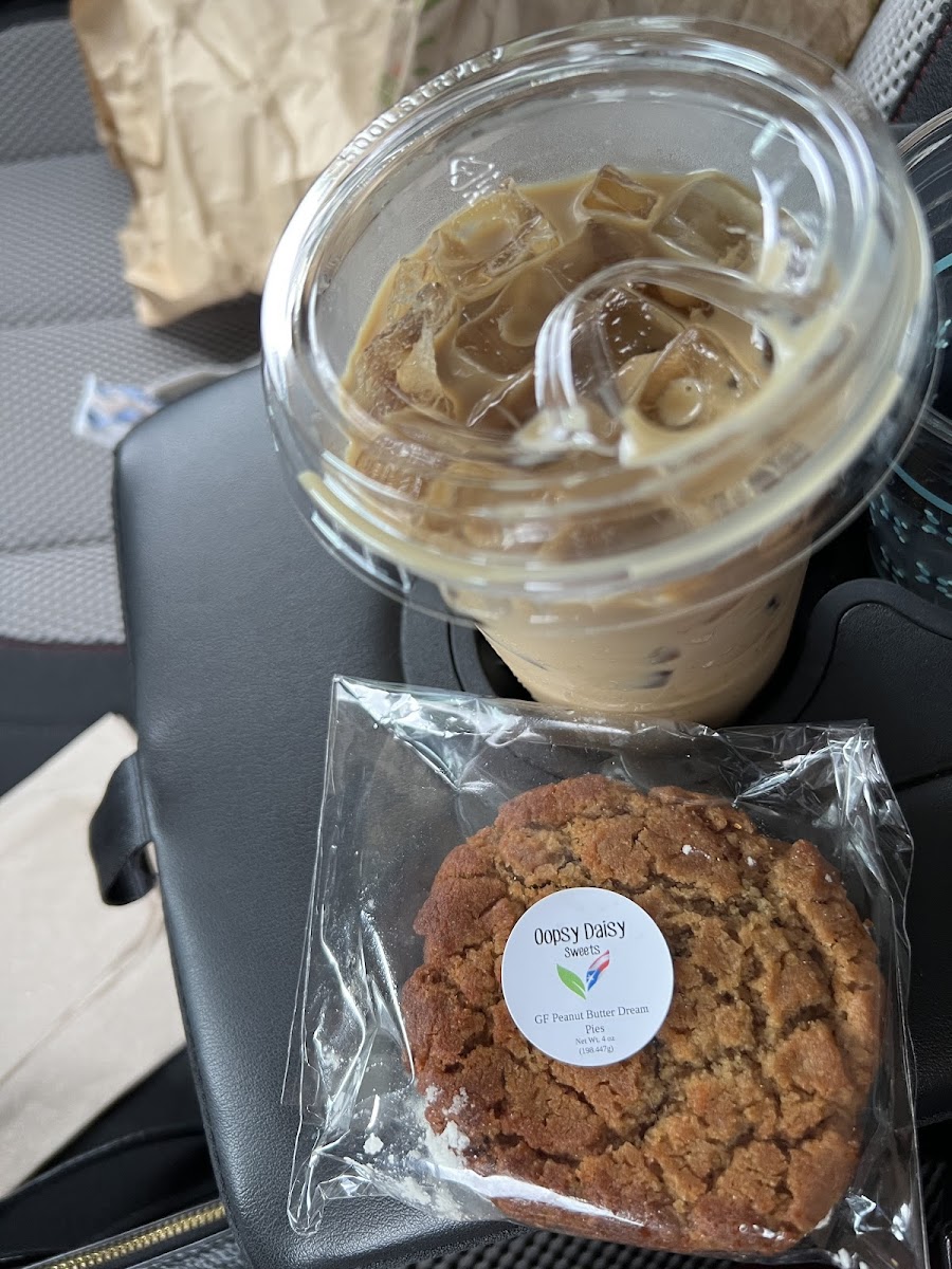 A gluten free peanut butter sandwich cookie and an iced latte