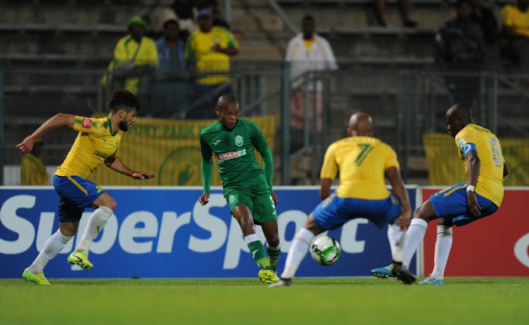 Fares Hachi,Oupa Manyisa and Hlompho Kekana of Mamelodi Sundowns in action with Lungelo Dlamini of Amazulu during the Absa Premiership match between Mamelodi Sundowns and AmaZulu FC at Lucas Masterpieces Moripe Stadium on October 21, 2017 in Pretoria, South Africa.
