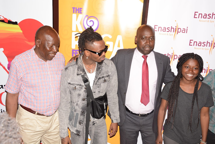 Tanzanian singer Diamond (in sunglasses) joins fans and organisers of the Naivasha Love Festival during a media briefing at Enashipai Spa in Naivasha.