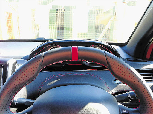 The steering wheel blocks the writer's view of the dials