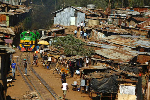 A train passes through Kibera slums