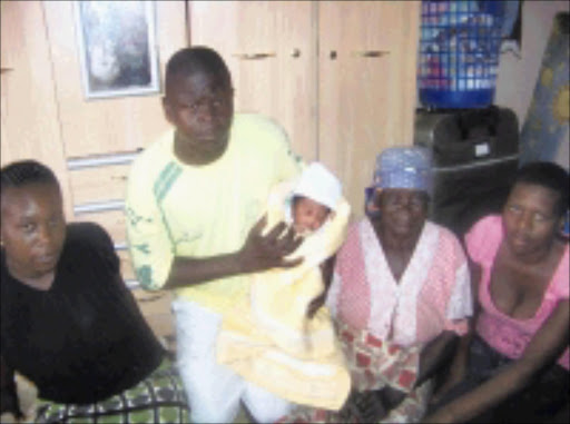 INNOCENT BUNDLE: From left to right, Eunice Leshaba, the child's mother; Joseph Qhibi, the child's father with the child in his arms; the child's grandmother Hluphasi Qhibi and Jane Mambane who helped Leshaba give birth to the child in a minibus taxi.14/03/09. Pic. Riot Hlatshwayo. © Sowetan.
