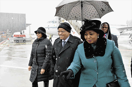 COLD COMFORT: President Jacob Zuma and wife Bongi, right, are welcomed by the South African ambassador to Switzerland Claudinah Ramosepele, left, on their arrival in Zurich. Zuma will attend the World Economic Forum in Davos with a number of cabinet ministers