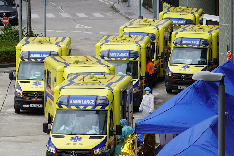 Medical workers and ambulances are seen outside Caritas Medical Centre in Cheung Sha Wan district, following the coronavirus disease (Covid-19) outbreak in Hong Kong, China February 18, 2022.