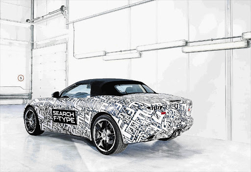 Jaguar has released pictures of a disguised F-Type undergoing testing ahead of the British sports car's launch