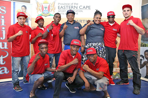 THE HIT PARADE: Boxers taking part in the Friday tournament pose with Sijuta Promotions boss Andile Sidinile and MEC for Sport, Recreation, Arts and Culture, Pemmy Majodina, at the FItness Joint gym in Mdantsane yesterday Picture: MARK ANDREWS