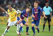 Iñigo Ruiz de Galarreta of Barcelona FC tackle Khama Billiat of Mamelodi Sundowns during the International Club Friendly match between Mamelodi Sundowns and Barcelona FC at FNB Stadium on May 16, 2018 in Johannesburg, South Africa. 