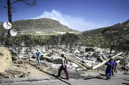 DEVASTATION: Residents started rebuilding on Saturday after fire ravaged the Mandela Park community near Hout Bay