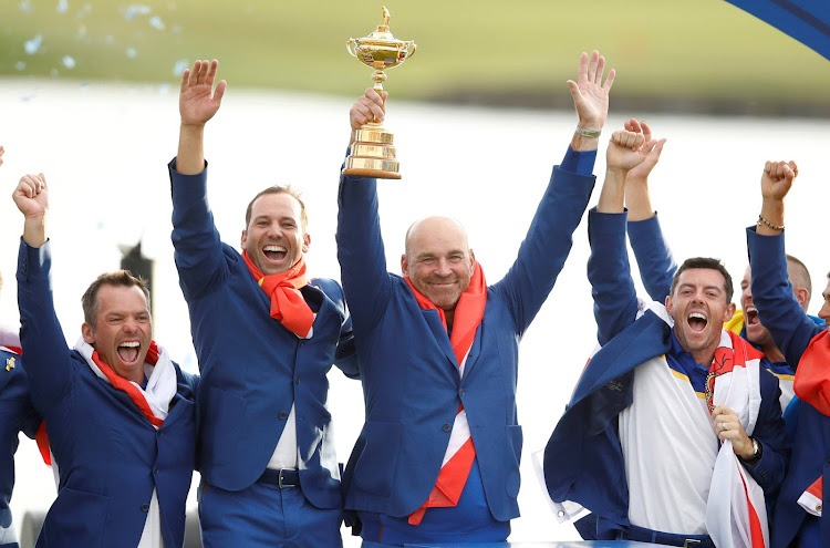 Team Europe captain Thomas Bjorn lifts the trophy as they celebrate after winning the Ryder cup.