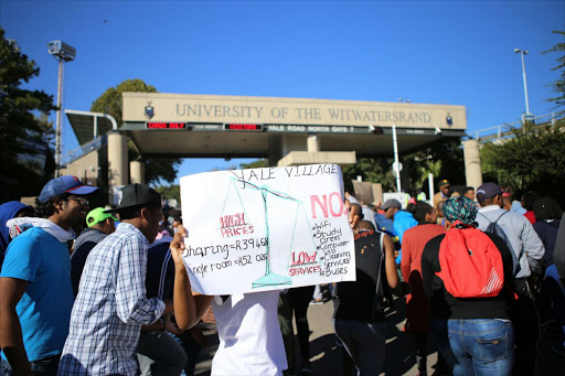 Students gather outside the University of Witwatersrand's Empire Road entrance where they are protesting against the cost and lack of infrastructure at the Yale Village residence.