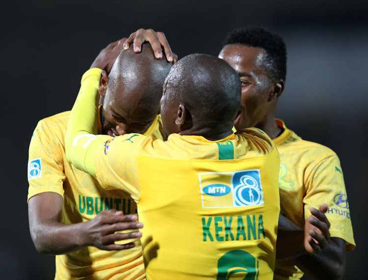 Mamelodi Sundowns utility defender Mosa Lebusa (L) celebrates with teammates Hlompho Kekana (C) and Lebohang Maboe after scoring the second goal.
