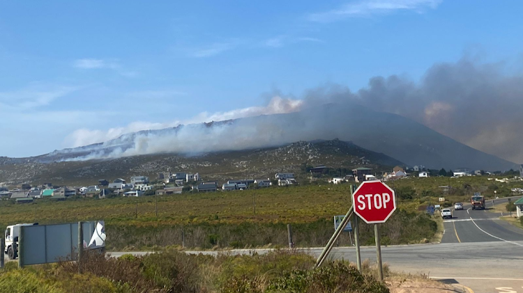 A wildfire rages above homes in Pringle Bay.