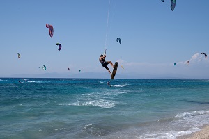People kite surf at Mylos beach, following the easing of measures against the spread of the coronavirus disease (Covid-19), on the island of Lefkada, Greece. The government has been accused of using Covid-19 emergency laws to crush protests.