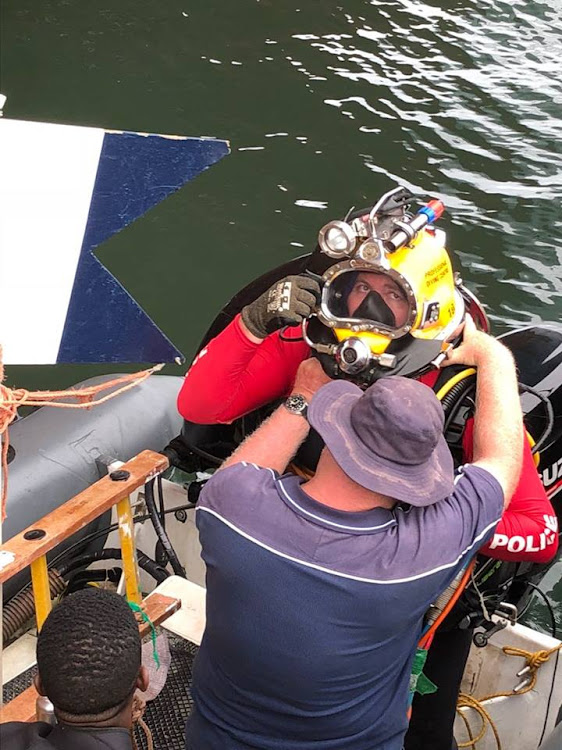 An SAPS Search and Rescue diver is fitted with his breathing apparatus during the search for the missing diver on Wednesday.