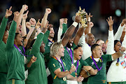 SA players celebrate as Siya Kolisi holds aloft the Web Ellis Cup after their victory against England in the Rugby World Cup 2019 on November 2 2019 in Japan.