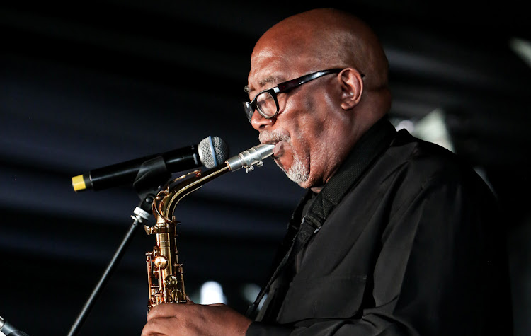 Sipho Hotstix Mabuse performs a musical item for the late poet.