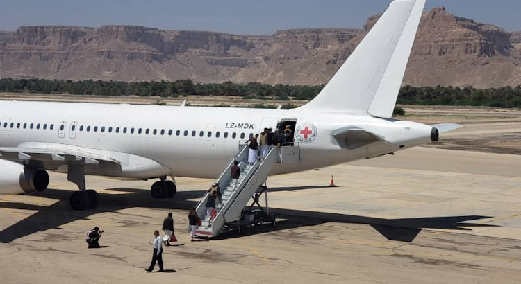 Houthi prisoners board a plane before heading to Sanaa airport after being released by the Saudi-led coalition in a prisoner swap, at Sayoun airport, Yemen October 15, 2020.