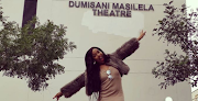 Dumi Masilela's widow, Simz Ngema, poses outside the renamed Dumisani Masilela Theatre.