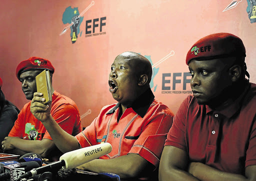 CONSTITUTION HANDBOOK: Julius Malema tells a media conference the EFF feels vindicated by Chief Justice Mogoeng Mogoeng's ruling that President Jacob Zuma has just over three months to pay back the money for some of the upgrades to his Nkandla homestead. Mogoeng said: 'The failure by the president to comply with remedial action taken against him by the public protector .is inconsistent with the constitution...and is invalid'