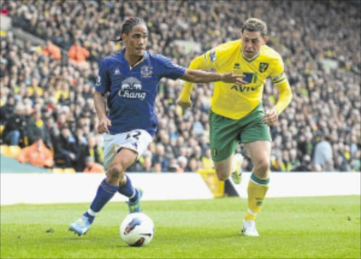 GROWING IN STATURE: Everton's Steven Pienaar, left, is challenged by Norwich's Grant Holt in their Premiership clash at Carrow Road in Norwich on Saturday. Photo: Getty Images