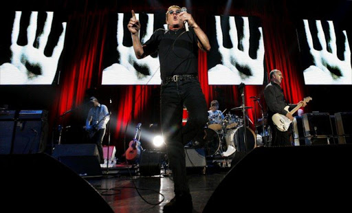 Singer Roger Daltrey (C) and guitarist Pete Townshend (R) of British rock band The Who perform on stage 13 June 2007 at the Olympiahalle in Munich.