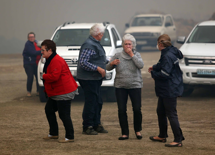 Buffalo Bay residents were evacuated on Saturday afternoon as roaring flames closed in on the Garden Route coastal community.