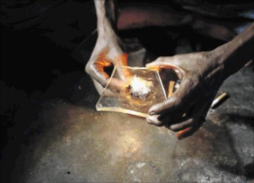 HOOKED: A heroin addict prepares heroin before using it in Lamu