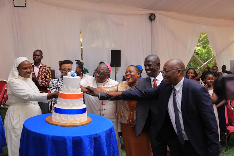The Archibishop Paul Ssemwogerere, ,ED Dr. Julius Luyimbazi and staff cut cake as they start activities to celebrate 125 years of Lubaga Hospital Anniversary