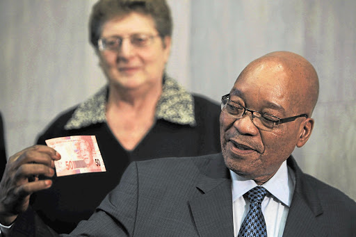 FACE VALUE: President Jacob Zuma and South African Reserve Bank governor Gill Marcus show off a new banknote honouring Nelson Mandela Picture: JAMES OATWAY